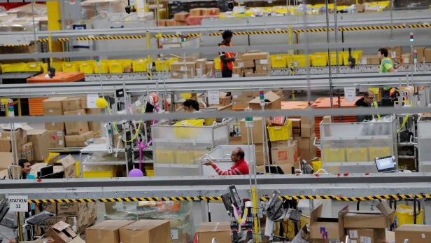 FILE PHOTO: FILE PHOTO: Amazon workers perform their jobs inside of an Amazon fulfillment center on Cyber Monday in Robbinsville, New Jersey