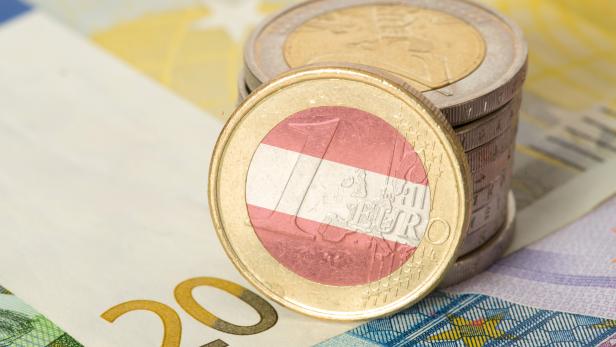 Euro notes and coins and flag of Austria