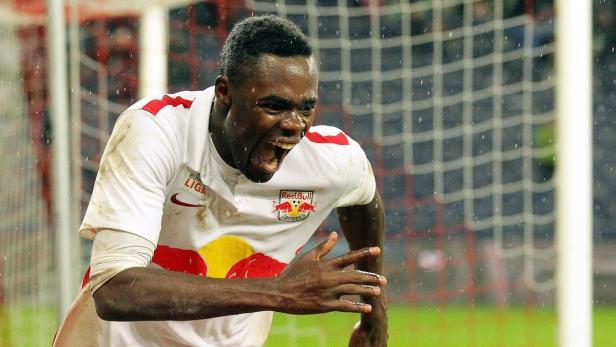 Ein jubelnder Fußballspieler im Trikot von Red Bull Salzburg vor einem Tornetz.