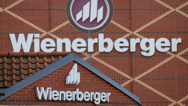 FILE PHOTO: Logos of Wienerberger, the world's biggest brick maker, are pictured at its headquarters in Hennersdorf