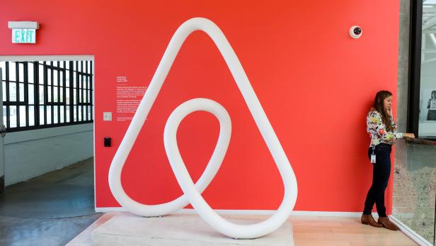 FILE PHOTO: A woman talks on the phone at the Airbnb office headquarters in the SOMA district of San Francisco