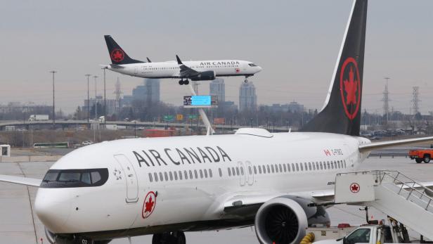 FILE PHOTO: An Air Canada Boeing 737 MAX 8 from San Francisco approaches for landing at Toronto Pearson International Airport over a parked Air Canada Boeing 737 MAX 8 aircraft in Toronto