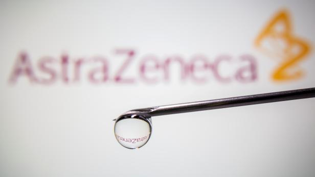 FILE PHOTO: AstraZeneca's logo is reflected in a drop on a syringe needle in this illustration