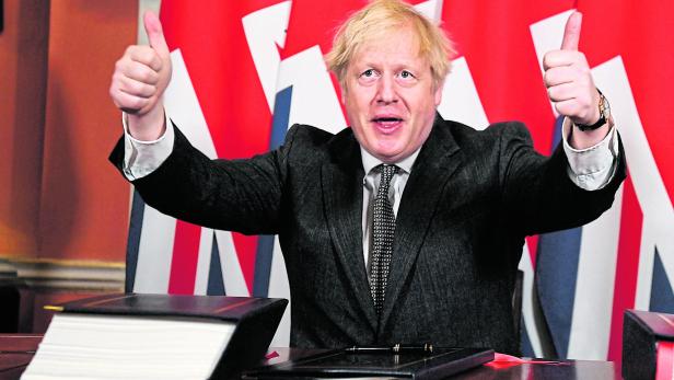 FILE PHOTO: Britain's Prime Minister Boris Johnson signs the Brexit trade deal with EU