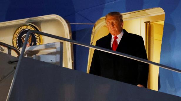 U.S. President Donald Trump disembarks from Air Force One at Joint Base Andrews in Maryland