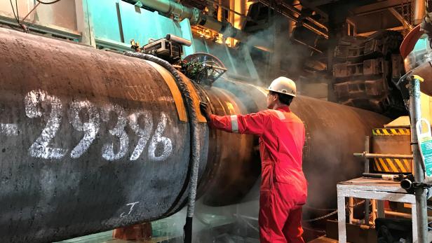 FILE PHOTO: A specialist works onboard the Allseas' deep sea pipe laying ship Solitaire to prepare a pipe for Nord Stream 2 pipeline in the Baltic Sea