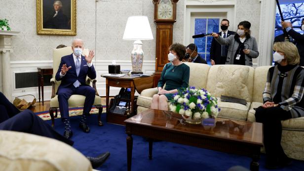 Senators Collins and Murkowski watch U.S. President Biden during a discussion with Republican Senators on coronavirus disease federal aid legislation at the White House in Washington