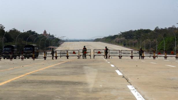 Soldiers stand guard at a Myanmar's military checkpoint on the way to the congress compound in Naypyitaw