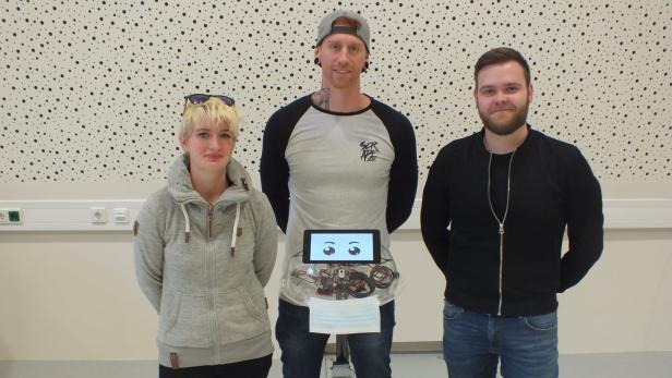 Die Studierenden Saskia Willixhofer (26), Ladislav Zechmeister (33) und Stefan Dimnik (29) mit ihrem Roboter „Alfred“