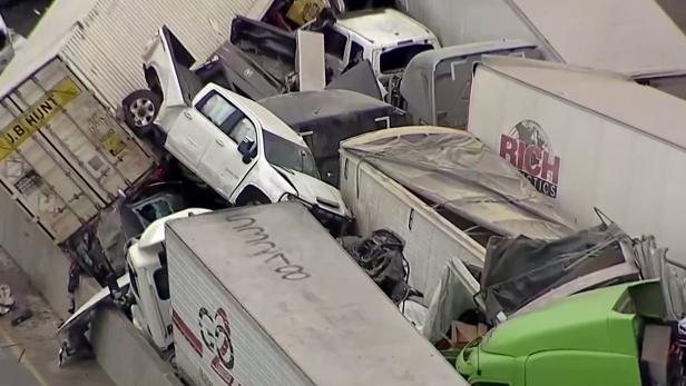 Cars and trucks are wedged together after a morning crash on the ice covered I-35 in Fort Worth