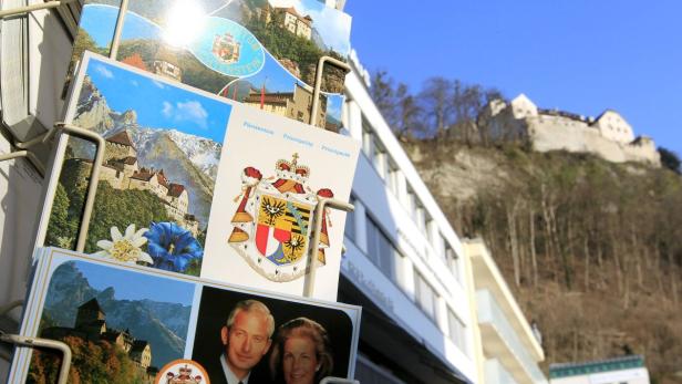 Postcards with the portraits of Prince Hans Adam II and Princess Marie of Liechtenstein are pictured in Liechtenstein&#039;s capital Vaduz in this March 14, 2012 file photo. Everybody knows everybody in this arch-conservative state and the subjects of the last monarchy in Europe with any real power don&#039;t like rocking the boat. Activists who want to end the monarchy&#039;s right to veto popular referendums say they have received threatening letters and seen far-right vandals deface campaign posters with Nazi slogans. But democracy campaigners still managed to gather just enough signatures to call a referendum on the prince&#039;s veto right - set for July 1, 2012 - by canvassing support in private and assuring voters that their names would be kept secret. Picture taken March 14, 2012. To match Insight LIECHTENSTEIN-PRINCE/ REUTERS/Arnd Wiegmann/Files (LIECHTENSTEIN - Tags: CITYSCAPE ROYALS TRAVEL)
