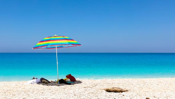 Blue sea, white beach and colorful umbrella