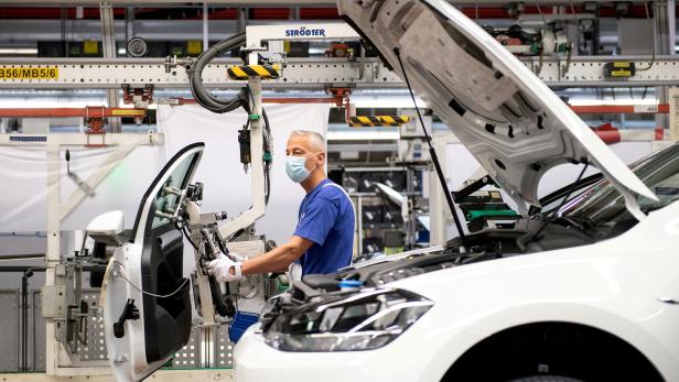 FILE PHOTO: A worker at the Volkswagen assembly line in Wolfsburg, Germany
