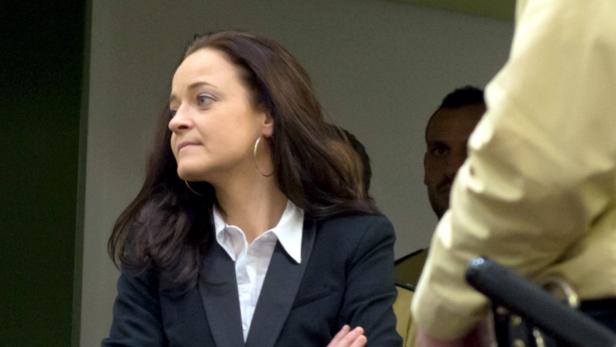 epa03689307 Accused Beate Zschaepe (l) arrives for the start of her trial at the Higher Regional Court in Munich, Germany, 06 May 2013. Accused neo-Nazi terrorist Beate Zschaepe went on trial in Munich 06 May for her involvement in a series of racially motivated murders, bombings and robberies committed by an extreme right-wing underground group, the National Socialist Underground (NSU). The 38-year-old Zschaepe faces charges of being a founding member of a terrorist organization along with arson and attempted murder. The NSU group is believed to have carried out the execution-style murders of eight Turkish immigrants and one Greek man as well as a German policewoman over a period of seven years. EPA/PETER KNEFFEL