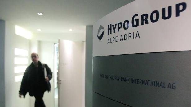 A man leaves the office of nationalised Austrian lender Hypo Alpe Adria in Vienna March 12, 2013. Hypo Alpe Adria boost its total capital ratio to 13.0 percent at the end of 2012, above the level required by regulators even for the end of 2013, it said on Tuesday. REUTERS/Heinz-Peter Bader (AUSTRIA - Tags: BUSINESS)