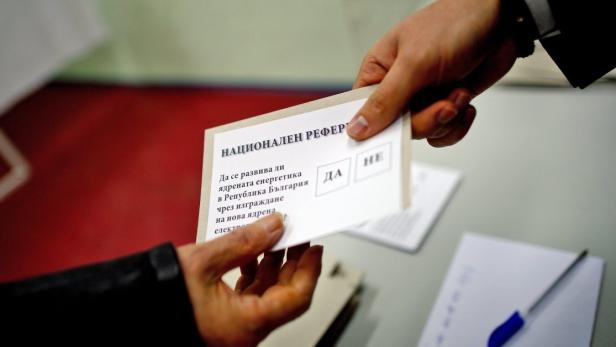 epa03557809 Voter takes a ballot with text &#039;To develop a nuclear energy in Bulgaria by building a new nuclear power plant?&#039; before voting at a polling station during the national referendum on the future of Bulgaria&#039;s nuclear energy, Sofia, Bulgaria 27 January 2013. Bulgarians began casting ballots Sunday in the first democratic referendum in the Balkan country. The vote is about the future of nuclear project with Russia at Belene on the Danube river. But turnout is expected to fall short of the required 60 per cent because many voters are confused by the question: &#039;Should nuclear energy be developed in Bulgaria through the construction of a new nuclear power plant?&#039;. The center-right government of Prime Minister Boyko Borisov stopped the construction of the Belene nuclear plant due to its high costs for the poorest EU member state. The opposition Socialists, on the contrary, are in favour of a new nuclear plant, the country&#039;s second after the Soviet style Kozloduy nuclear power plant. EPA/VASSIL DONEV