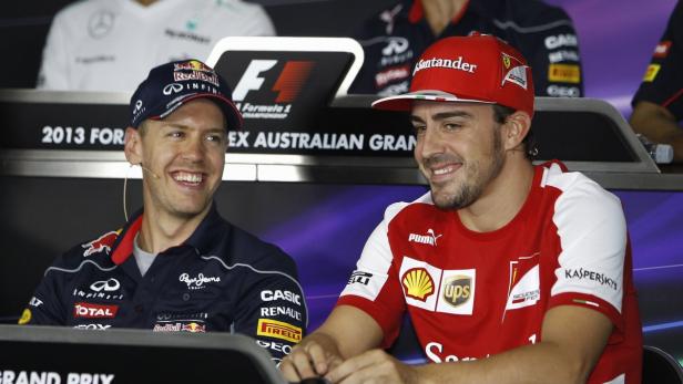 Red Bull Formula One driver Sebastian Vettel (L) of Germany smiles with Ferrari Formula One driver Fernando Alonso of Spain during the official news conference at Albert Park circuit in Melbourne March 14, 2013, ahead of the Australian F1 Grand Prix. REUTERS/Brandon Malone (AUSTRALIA - Tags: SPORT MOTORSPORT)
