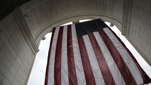 A large U.S. flag hangs in front of Union Station ahead of the Fourth of July Independence Day observance in Washington, July 3, 2013. Security will be tighter than ever in several U.S. cities during Independence Day celebrations this week, which will see some of the largest public gatherings in the country since the deadly Boston Marathon bombings in April. REUTERS/Jonathan Ernst (UNITED STATES - Tags: SOCIETY ANNIVERSARY TRANSPORT)