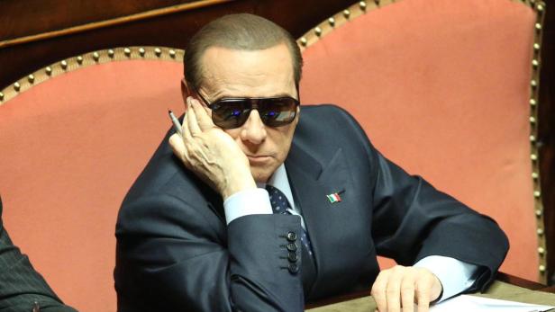 epa03692254 (FILE) A file picture dated 16 March 2013 of the former Italian prime minister Silvio Berlusconi, who only left hospital in Milan the day before after eye treatment, wears sunglasses as he takes his seat after casting his vote for a new Italian Senate president ,in Rome, Italy. An Italian appeals court on 08 May 2013 upheld a tax fraud conviction against former premier Silvio Berlusconi. In October 2012, Berlusconi was sentenced to four years&#039; imprisonment with a three-year remit; banned from holding public office for five years; and excluded from managerial positions in private companies for three years. EPA/ALESSANDRO DI MEO *** Local Caption *** 50755254