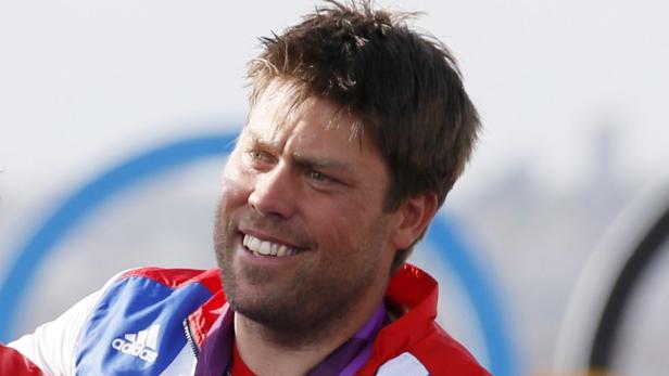 Silver medallist Andrew Simpson of Britain smiles during his men&#039;s star class keelboat sailing medal race victory ceremony at the London 2012 Olympic Games in Weymouth and Portland, southern England in this August 5, 2012 file photo. Simpson died May 9, 2013 when a yacht capsized off the Northern California coast during training for the America&#039;s Cup race. REUTERS/Pascal Lauener/Files (BRITAIN - Tags: SPORT YACHTING OLYMPICS)