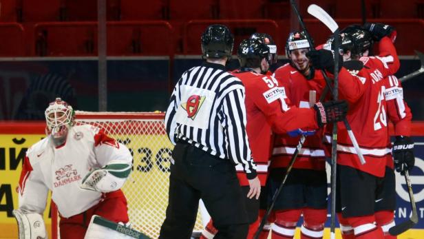 Switzerland&#039;s players celebrate their goal in front of Denmark&#039;s goalie Patrick Galbraith during their 2013 IIHF Ice Hockey World Championship preliminary round match at the Globe Arena in Stockholm May 11, 2013. REUTERS/Arnd Wiegmann (SWEDEN - Tags: SPORT ICE HOCKEY)