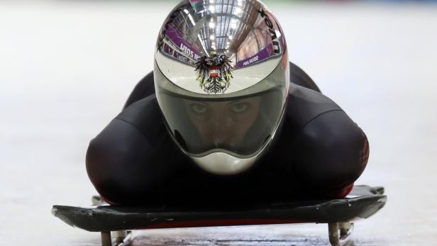 The track is reflected on the helmet of Austria's