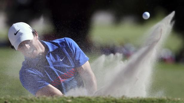 Northern Ireland's McIlroy hits out of a bunker on