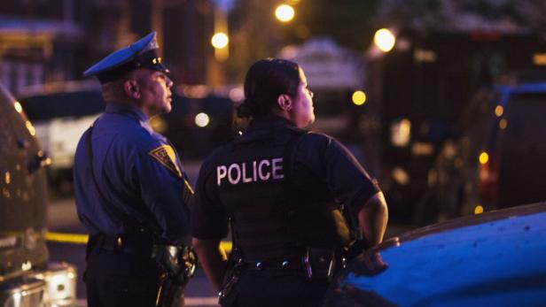 Police officers stand guard near a house, where an armed man with multiple hostages remain barricaded in, in Trenton, New Jersey, May 11, 2013. The man remained barricaded inside the house on Saturday after a standoff with law enforcement negotiators overnight, police said. Trenton Police Lieutenant Edelmiro Gonzalez told Reuters late on Friday that officers responding for a wellness check on someone at the house on Friday afternoon had encountered a man who barricaded himself inside. REUTERS/Eduardo Munoz (UNITED STATES - Tags: CRIME LAW)