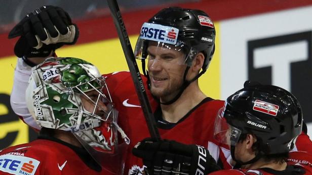 Austria&#039;s goalie Bernhard Starkbaum (L-R), Andre Lakos and Florian Iberer celebrate their win over Slovakia after their 2013 IIHF Ice Hockey World Championship preliminary round match at the Hartwall Arena in Helsinki May 10, 2013. REUTERS/Grigory Dukor (FINLAND - Tags: SPORT ICE HOCKEY)