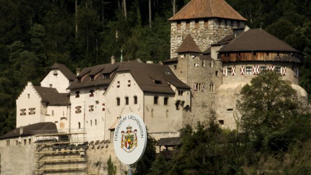 A sign marks the border between Liechtenstein and Switzerland near Vaduz August 15, 2012. In the background is seen Schloss Vaduz castle. REUTERS/Arnd Wiegmann (LIECHTENSTEIN - Tags: CITYSPACE)