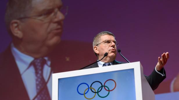 Thomas Bach, Präsident des IOC, hält eine Rede vor dem Hintergrund des Olympia-Logos.