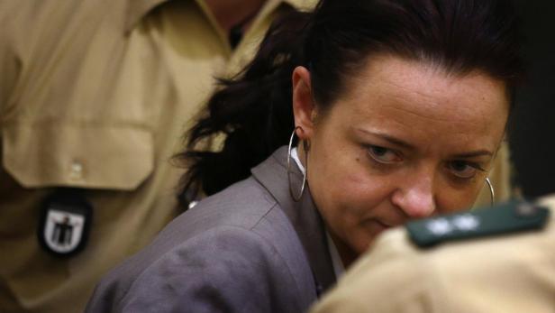 Defendant Beate Zschaepe arrives in the courtroom in Munich May 14, 2013. Proceedings in the trial against a previously unknown neo-Nazi cell, the National Socialist Underground (NSU), which is accused of murdering nine Turkish and Greek immigrants and a policewoman from 2000 to 2007, resumed on Tuesday. The focus of the trial is 38-year-old woman, Zschaepe, who is accused of being an NSU founder member and faces charges of complicity in the murders, two bombings in Cologne and 15 bank robberies. Four suspected male accomplices are also on trial. The existence of the NSU emerged in November 2011 after Uwe Boehnhardt and Uwe Mundlos of the NSU were found dead in a burnt-out mobile home and the third Zschaepe, gave herself in to police. REUTERS/Kai Pfaffenbach (GERMANY - Tags: CRIME LAW)