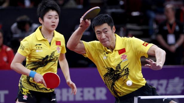 Wang Liqin (R) and Rao Jingwen (L) of China faces Robert Floras and Monika Pietkiewicz of Poland in their mixed doubles second round match at the World Team Table Tennis Championships in Paris May 15, 2013. The 52nd edition of the World Table Tennis Championships gathers 829 athletes from 162 countries and runs from May 13 to May 20. REUTERS/Charles Platiau (FRANCE - Tags: SPORT TABLE TENNIS)