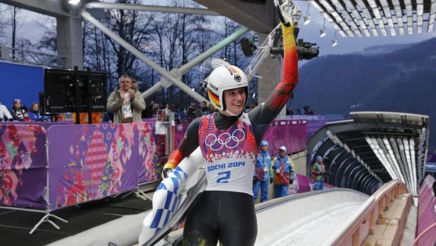 Eine deutsche Rennrodlerin jubelt mit erhobenem Arm auf der Bahn in Sotschi 2014.