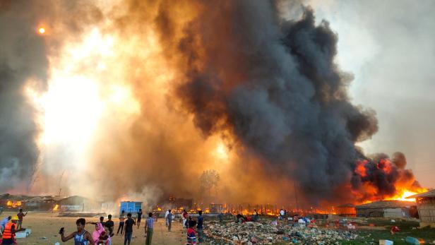 Smoke billows at the site of the Rohingya refugee camp where fire broke out in Cox's Bazar