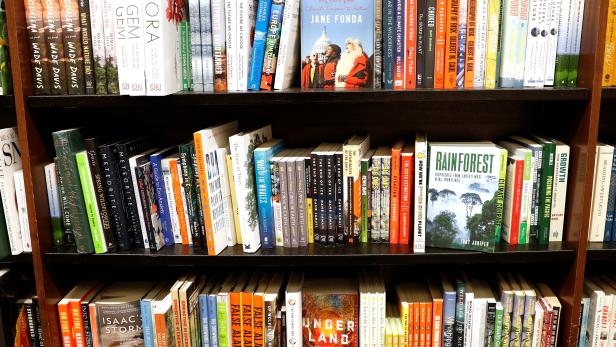 Climate change themed books are displayed together on shelves at a Barnes & Noble book store in Brooklyn, New York