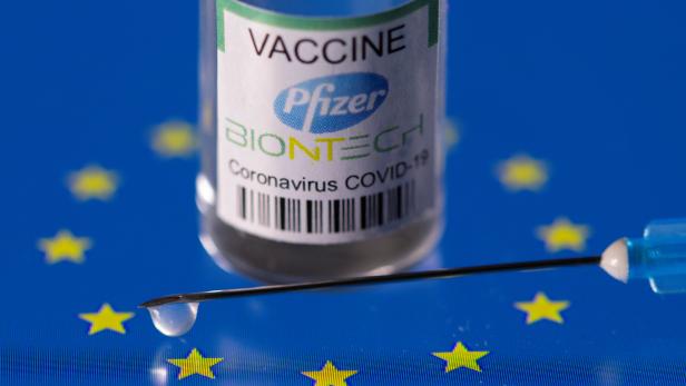 Vial labelled "Pfizer BioNtech coronavirus disease (COVID-19) vaccine" placed on a displayed EU flag is seen in this illustration picture
