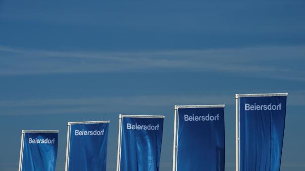 FILE PHOTO: Flags of German personal-care company Beiersdorf are pictured at the annual shareholders meeting in Hamburg