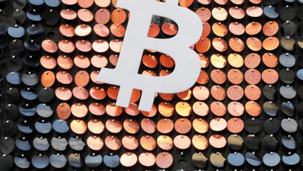 FILE PHOTO: FILE PHOTO: The logo of the Bitcoin digital currency is seen in a shop in Marseille