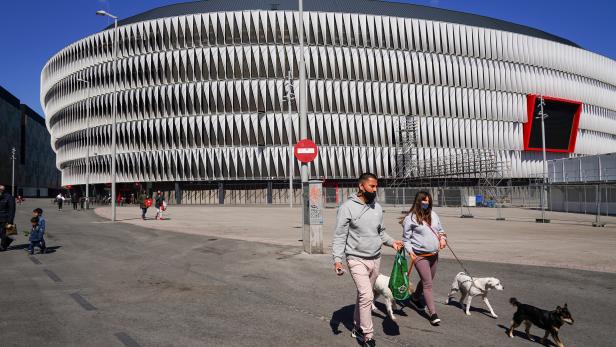 People walk dogs outside San Mames stadium, in Bilbao