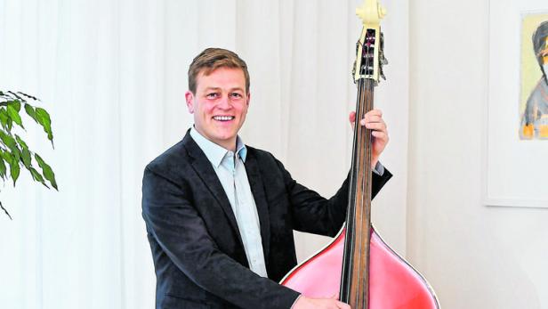 Stefan Kaineder spielt Kontrabass. Ein Instrument ziert sein Büro