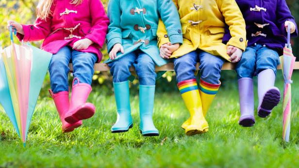 Kids in rain boots. Foot wear for children.