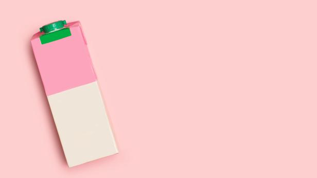 A pink and white milk brick on a pink background