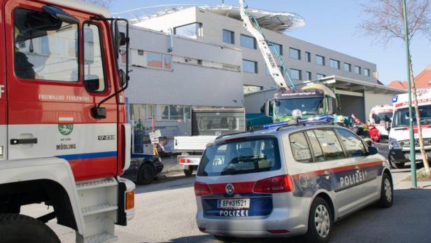 Ein Feuerwehrauto, ein Polizeiauto und ein Krankenwagen stehen vor einem Gebäude.