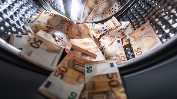 money laundering concept - euro banknotes in washing machine