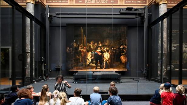 Children look at Rembrandt's famed Night Watch at Rijksmuseum in Amsterdam