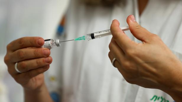 A medical worker prepares to administer a dose of a vaccine against the coronavirus disease (COVID-19) in Tel Aviv