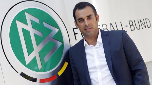 Robin Dutt, new technical director of the German Soccer Association (DFB), poses for pictures after a news conference in Frankfurt July 25, 2012. Dutt takes over from Matthias Sammer, who left the post to become sports director at Bayern Munich. REUTERS/Alex Domanski (GERMANY - Tags: SPORT SOCCER)