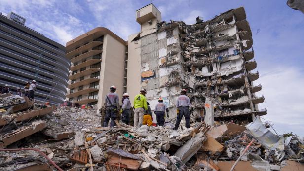 Search and rescue personnel work at the site of a collapsed Florida condominium complex in Surfside, Miami, U.S. in this picture obtained from social media