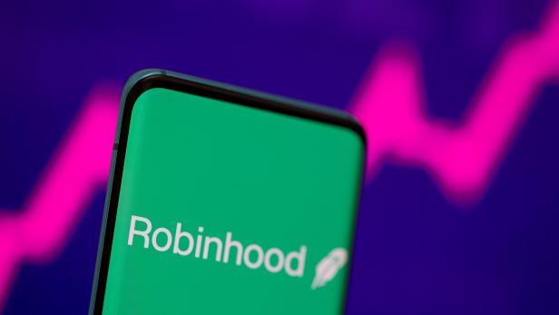 FILE PHOTO: Robinhood logo is seen on a smartphone in front of a displayed stock graph in this illustration taken